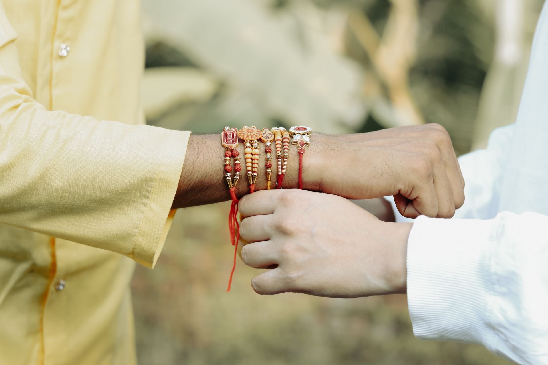 Raksha Bandhan rakhi being tied on wrist - Shoemato Rakhi Gifts Sale